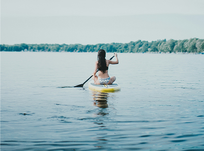 Sitting paddle boarder
